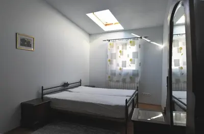 a small bedroom with a bed and a window at Old Town Sky Apartment in Kraków