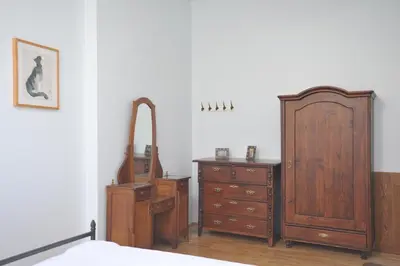 a bedroom with a bed and a dresser and a mirror at Old Town Sky Apartment in Kraków