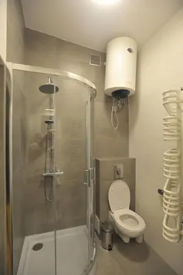 a bathroom with a shower and a toilet and a sink at Old Town Sky Apartment in Kraków
