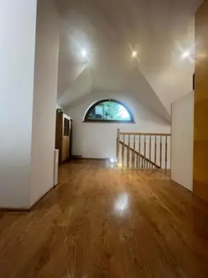 an empty room with a staircase and a window at Noclegi Wilga in Gromiec