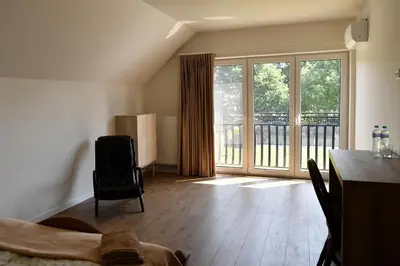 a living room with a table and a large window at Dobranocka Noclegi - blisko Energylandia in Spytkowice