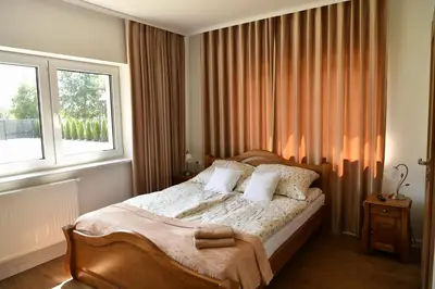 a bedroom with a bed with two pillows and a window at Dobranocka Noclegi - blisko Energylandia in Spytkowice