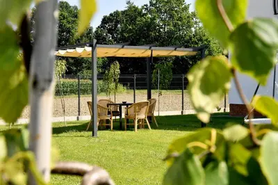 a table and chairs under a canopy in the grass at Dobranocka Noclegi - blisko Energylandia in Spytkowice