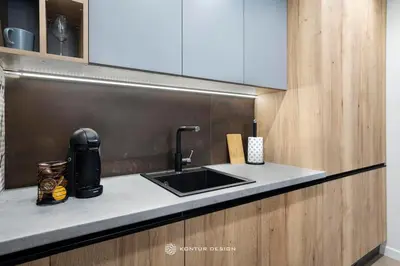a kitchen with a sink and a counter top at City of the Kings-Szmaragd in Kraków