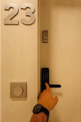 a person pointing at a clock with a remote control at City of the Kings-Szmaragd in Kraków