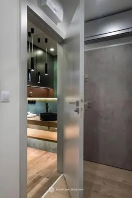 a bathroom with a door leading into a bathroom with a sink at City of the Kings-Szmaragd in Kraków