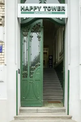 a green entrance to a building with a happy tower sign at Happy Tower in Kraków