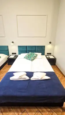 a bedroom with a bed with two towels on it at Happy Tower in Kraków