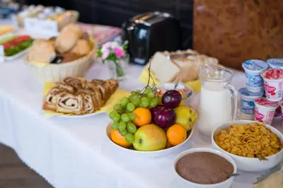 a table topped with bowls of fruit and other foods at Happy Tower in Kraków