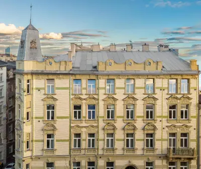 a sign on the side of a building that reads happy tower apartments at Happy Tower in Kraków