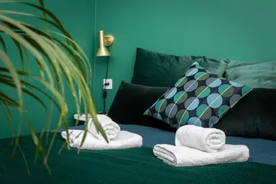 a living room with towels on a couch at Barbacan Suites - Old Town Apartments - by Upstairs in Kraków