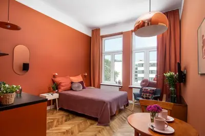 a hotel room with a bed and a window at Barbacan Suites - Old Town Apartments - by Upstairs in Kraków