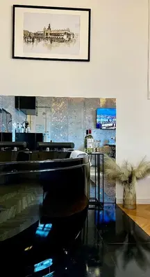 a room with a table and a picture on the wall at Krakow Old Town Apartment Jacuzzi - wymeldowanie do 13 in Kraków