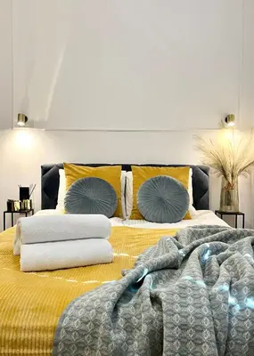 a bedroom with a bed with pillows on it at Krakow Old Town Apartment Jacuzzi - wymeldowanie do 13 in Kraków