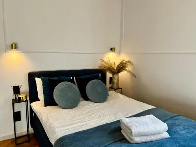 a bedroom with a bed with blue and white at Krakow Old Town Apartment Jacuzzi - wymeldowanie do 13 in Kraków