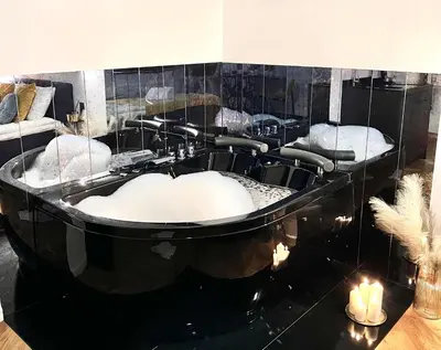 a black bath tub with four sinks in a room at Krakow Old Town Apartment Jacuzzi - wymeldowanie do 13 in Kraków
