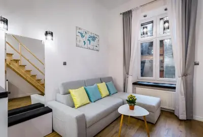 a living room with a couch and a table at Cozy Stay Apartment - Kazimierz in Kraków