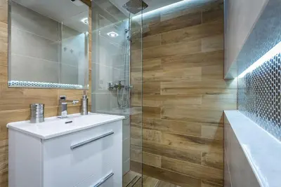 a bathroom with a white sink and a shower at Cozy Stay Apartment - Kazimierz in Kraków
