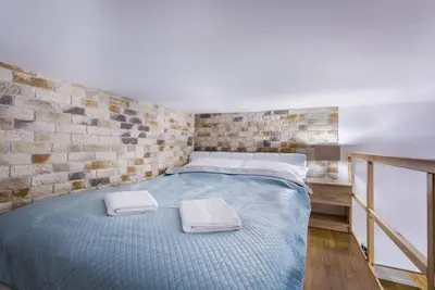 a bedroom with a bed with two towels on it at Cozy Stay Apartment - Kazimierz in Kraków