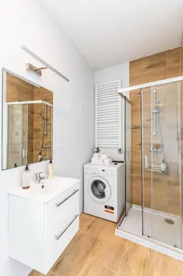 a bathroom with a washing machine and a washer at Apartment Quiet Street 11, 3E in Oświęcim
