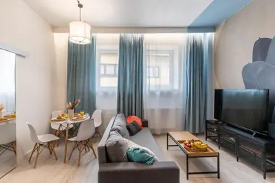 a living room with a couch and a tv and a table at Apartment Quiet Street 11, 3E in Oświęcim