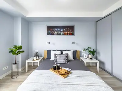 a bedroom with a large bed with a tray on it at Apartament z widokiem na panoramę miasta in Kraków