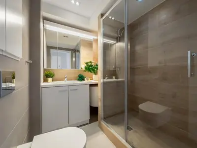 a bathroom with a shower and a toilet and a sink at Apartament z widokiem na panoramę miasta in Kraków