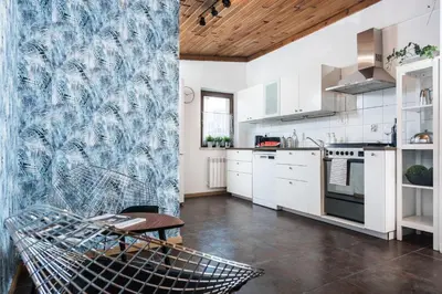 a kitchen with white cabinets and a wooden ceiling at Urok Centrum: Podwójne Piękno in Kraków