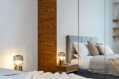 a mirror in a bedroom with a bed and a chair at Modern Apartments with FREE parking spots in Kraków