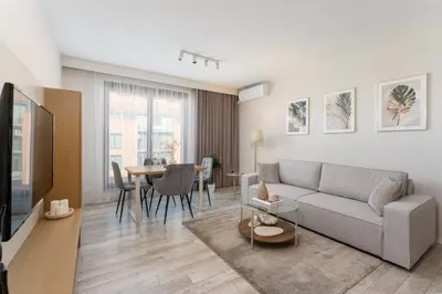 a living room with a couch and a table at Modern Apartments with FREE parking spots in Kraków