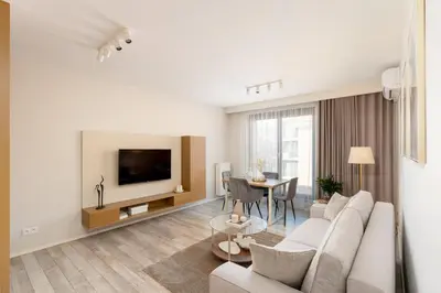 a white living room with a couch and a table at Modern Apartments with FREE parking spots in Kraków