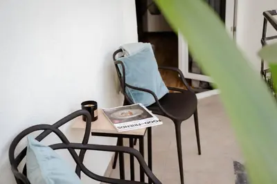 a room with a chair and a book on a table at Copernicus House in Kraków