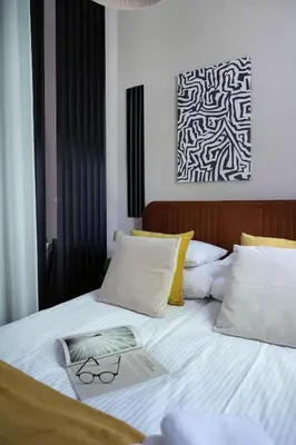 a bed with a pair of glasses on it at Copernicus House in Kraków
