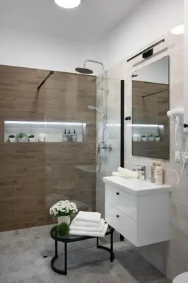 a bathroom with a white sink and a shower at Copernicus House in Kraków