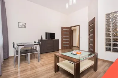 a living room with a table and a dining room at Luxor in Kraków