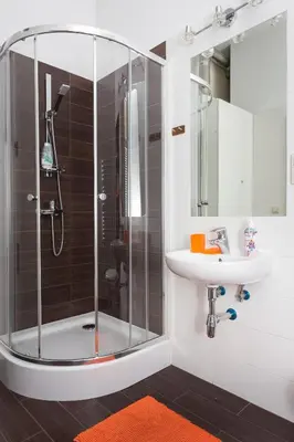 a bathroom with a shower and a sink at Luxor in Kraków