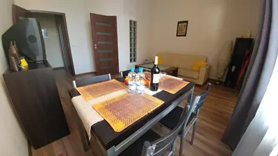 a dining room table with bottles of wine on it at Luxor in Kraków