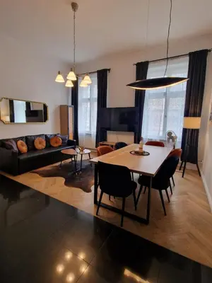 a living room with a table and a couch at Golden Pearl - Main Square, 100 sqm, 4 rooms in Kraków