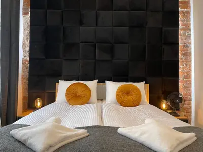 a bedroom with a bed with two pillows on it at Golden Pearl - Main Square, 100 sqm, 4 rooms in Kraków