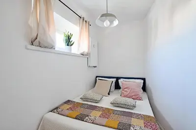 a bed in a room with a window and pillows at Urban Nest Apartments Starowiślna 30A in Kraków