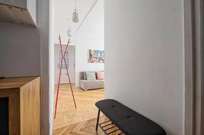 a living room with a chair and a couch at Urban Nest Apartments Starowiślna 30A in Kraków