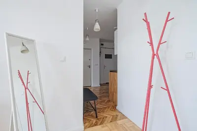 a tripod in a living room next to a white wall at Urban Nest Apartments Starowiślna 30A in Kraków