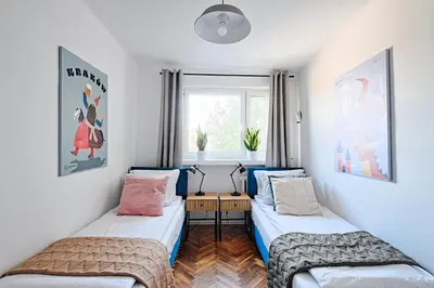 a bedroom with two beds and a window at Urban Nest Apartments Starowiślna 30A in Kraków