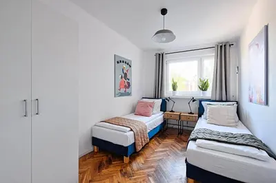 a small room with two beds and a window at Urban Nest Apartments Starowiślna 30A in Kraków