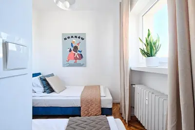 a small bedroom with two beds and a window at Urban Nest Apartments Starowiślna 30A in Kraków