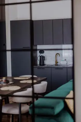 a kitchen with a table and chairs and a kitchen with a sink at Crown Pearl - wonderful apartment, 110scm, 4 rooms in Kraków