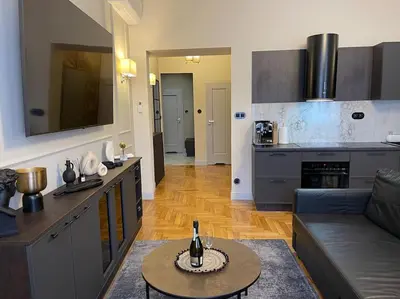 a kitchen and living room with a couch and a table at Crown Pearl - wonderful apartment, 110scm, 4 rooms in Kraków