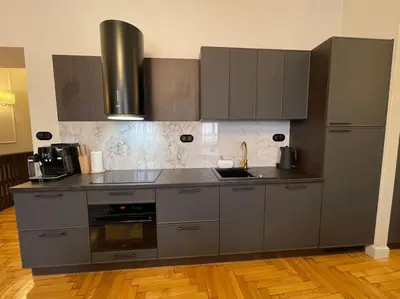 a kitchen with stainless steel appliances and wooden floors at Crown Pearl - wonderful apartment, 110scm, 4 rooms in Kraków