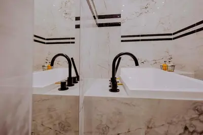 a bathroom with two sinks and two faucets at Crown Pearl - wonderful apartment, 110scm, 4 rooms in Kraków