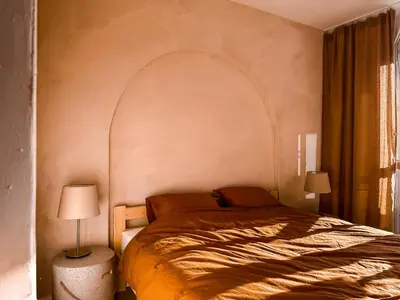 a bedroom with a bed and two lamps and a window at Sunset Stories Old Town Apartment in Kraków